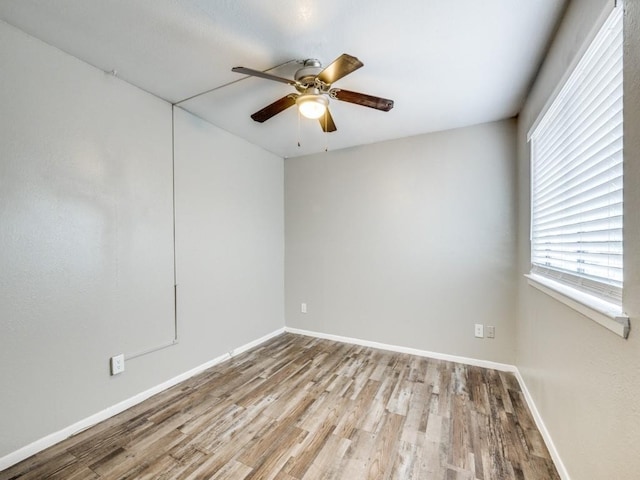 1122 Millview Dr Unit 405, Arlington, TX 76012 - spare room featuring baseboards, wood finished floors, and ceiling fan