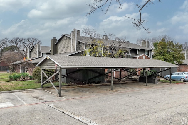 1122 Millview Dr Unit 405, Arlington, TX 76012 - exterior space featuring roof with shingles and covered parking