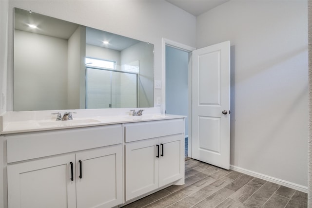 bathroom with vanity and a shower with shower door