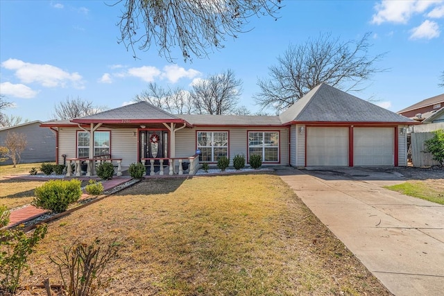 ranch-style house featuring a garage, driveway, covered porch, and a front yard