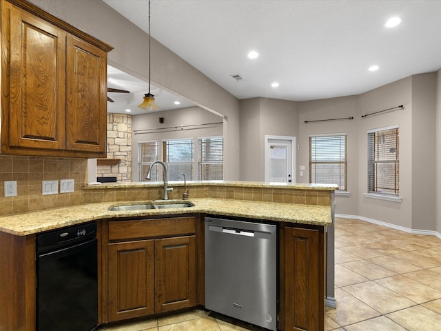 kitchen with sink, light stone counters, decorative backsplash, stainless steel dishwasher, and kitchen peninsula