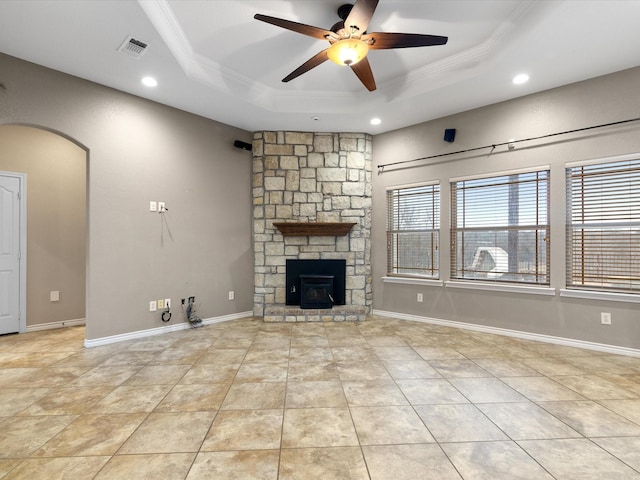 unfurnished living room featuring a raised ceiling, crown molding, light tile patterned flooring, and ceiling fan