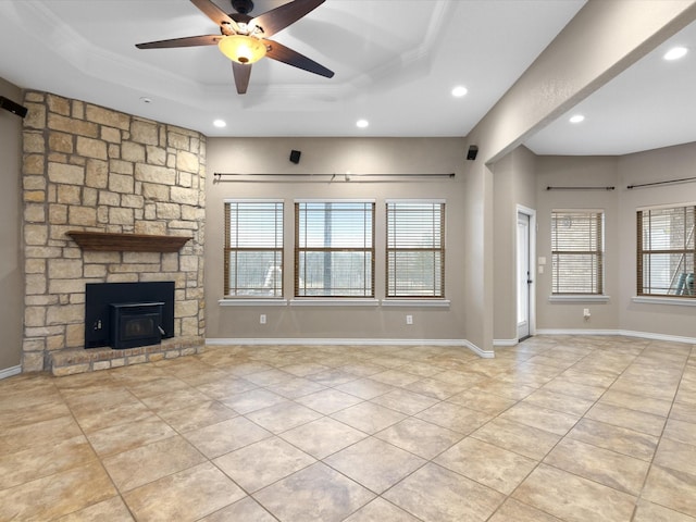 unfurnished living room featuring light tile patterned flooring, plenty of natural light, and a tray ceiling