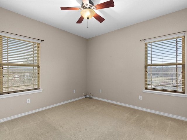 carpeted empty room with plenty of natural light and ceiling fan