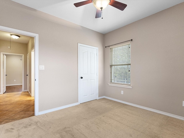 unfurnished bedroom with light carpet and ceiling fan