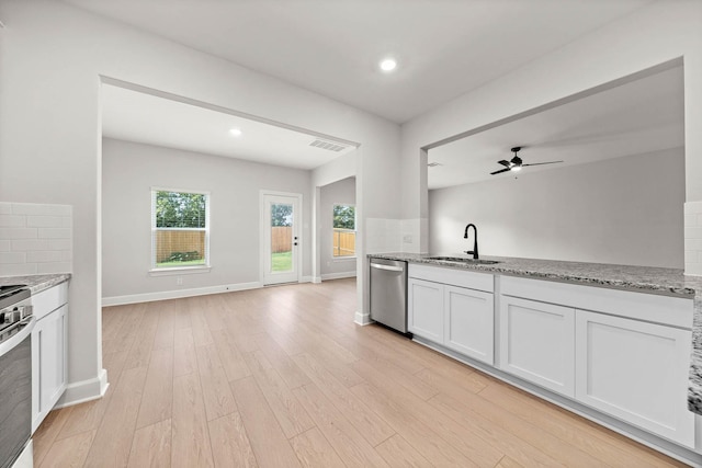 kitchen with tasteful backsplash, dishwasher, white cabinetry, sink, and light wood-type flooring