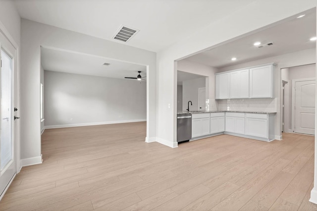 kitchen with dishwasher, backsplash, white cabinets, ceiling fan, and light hardwood / wood-style floors