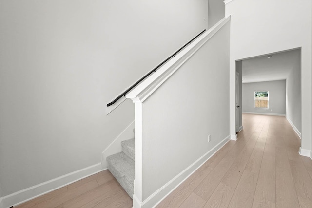 stairs with hardwood / wood-style floors