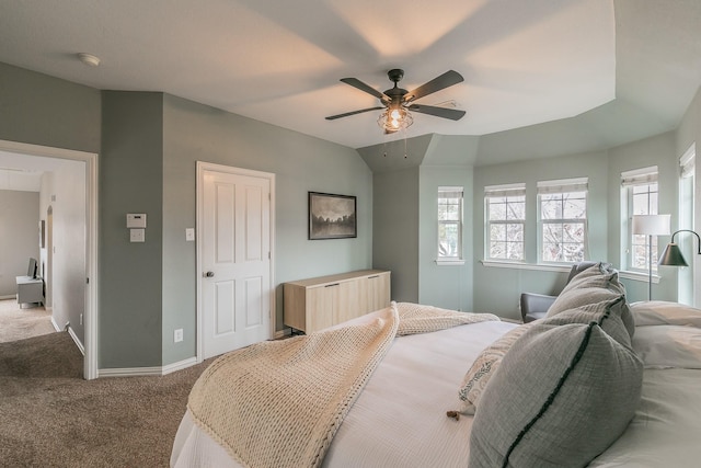 bedroom with vaulted ceiling, light colored carpet, and ceiling fan