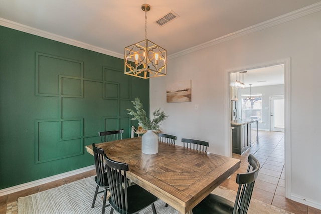 tiled dining room featuring crown molding and a notable chandelier