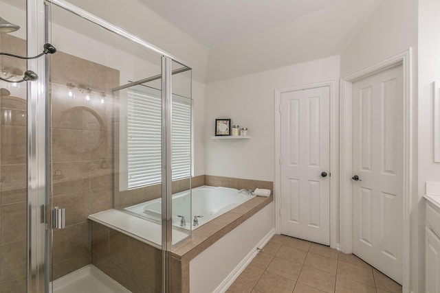 bathroom featuring vanity, shower with separate bathtub, and tile patterned flooring