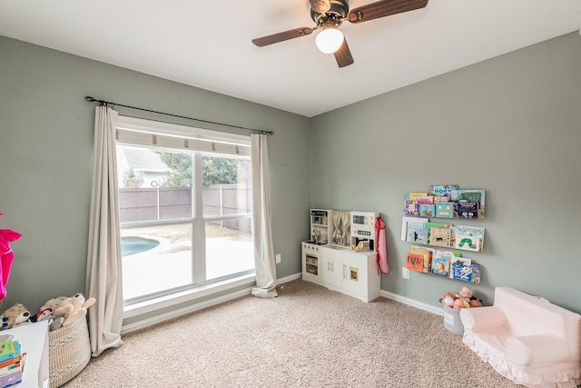 playroom featuring ceiling fan and carpet floors