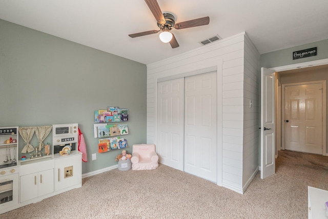 recreation room with light carpet and ceiling fan