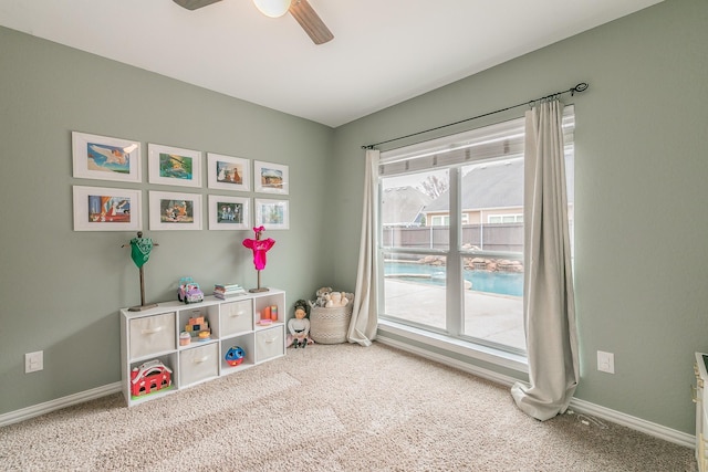 recreation room with ceiling fan and carpet flooring