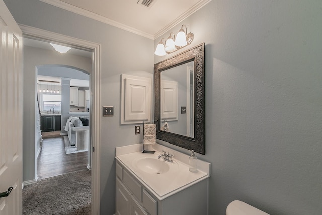 bathroom with ornamental molding and vanity