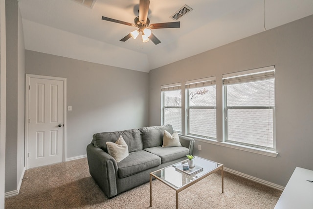 living room featuring carpet floors, vaulted ceiling, and ceiling fan