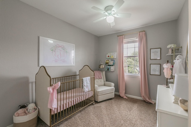 bedroom featuring ceiling fan, carpet, and a crib