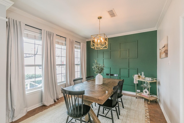 dining space featuring an inviting chandelier and ornamental molding