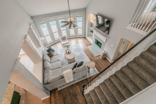 living room featuring ceiling fan and hardwood / wood-style floors