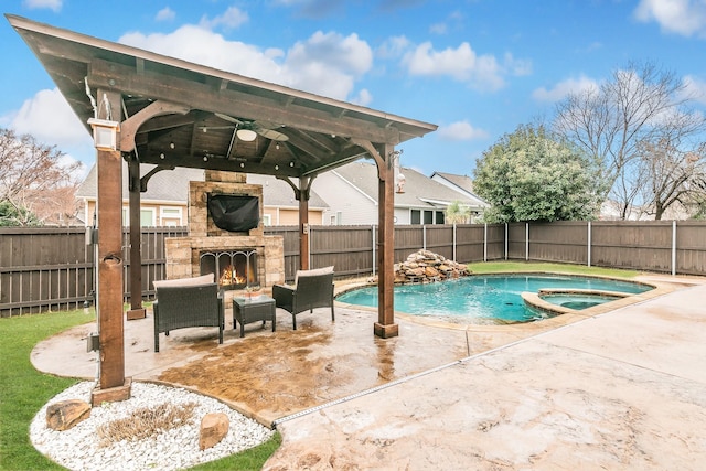 view of swimming pool featuring a patio, an in ground hot tub, a gazebo, and an outdoor stone fireplace