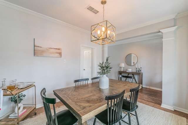 dining area with an inviting chandelier and crown molding