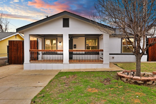 view of front of house with a yard and covered porch