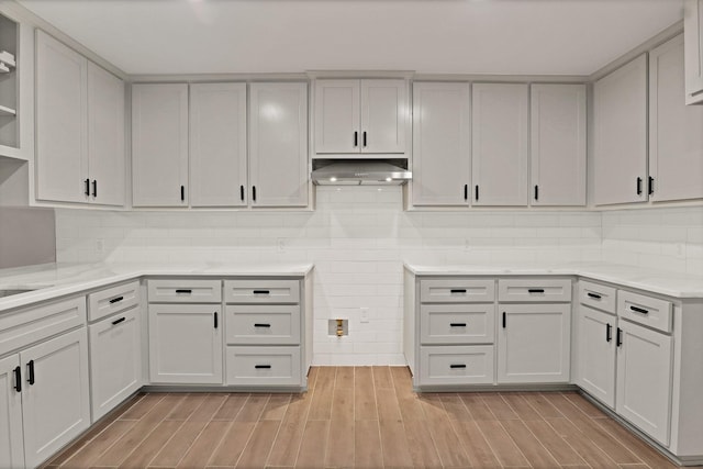 kitchen featuring white cabinetry and tasteful backsplash