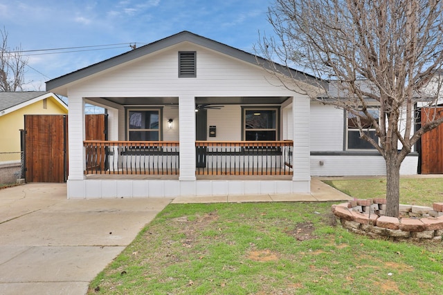 view of front of home with a porch and a front lawn