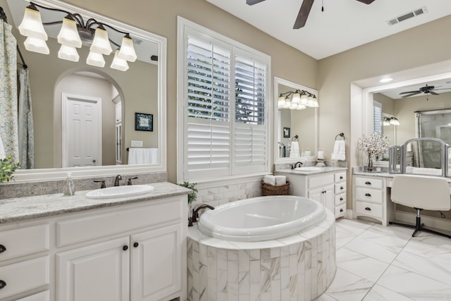 full bath featuring ceiling fan, a garden tub, two vanities, a sink, and visible vents