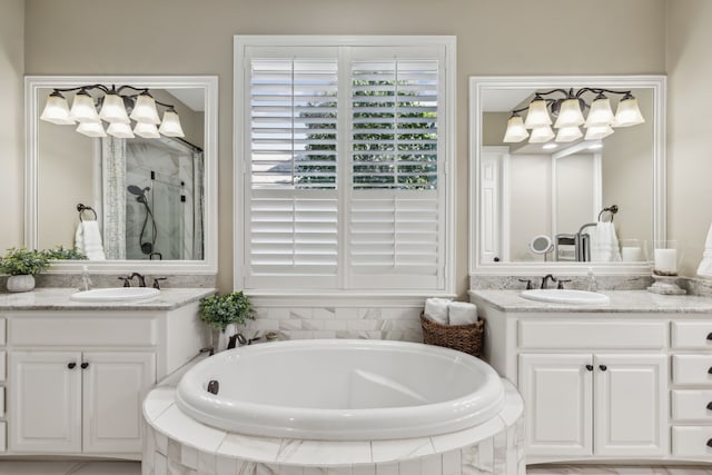 full bath featuring a stall shower, a garden tub, and a sink