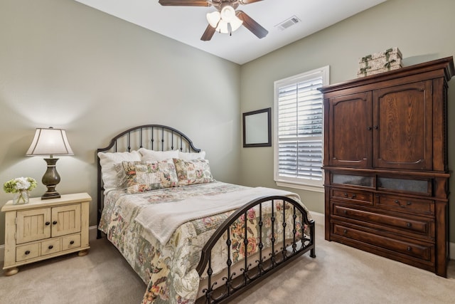 bedroom with light carpet, baseboards, visible vents, and a ceiling fan