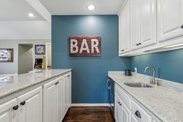 washroom featuring dark wood-type flooring, recessed lighting, a sink, and baseboards