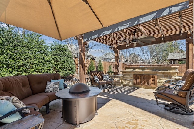 view of patio / terrace with exterior kitchen, a pergola, a fenced backyard, and an outdoor hangout area