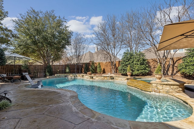 view of pool with a fenced in pool, a patio area, a fenced backyard, and an in ground hot tub