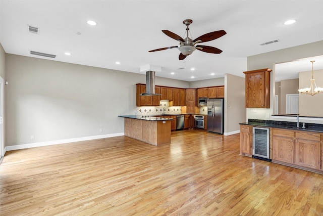 6039 Reiger Ave, Dallas, TX 75214 - kitchen with stainless steel appliances, a peninsula, visible vents, extractor fan, and beverage cooler