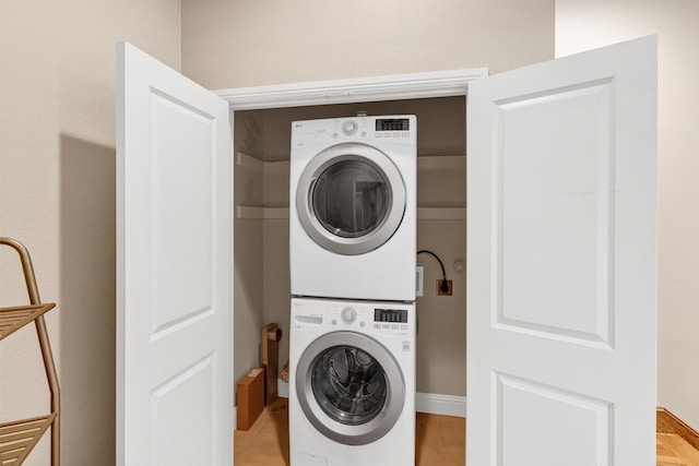 6039 Reiger Ave, Dallas, TX 75214 - washroom with stacked washing maching and dryer, laundry area, and light tile patterned floors