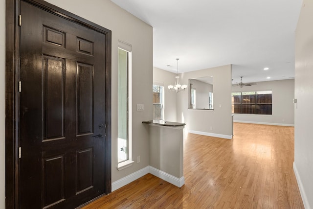 6039 Reiger Ave, Dallas, TX 75214 - entrance foyer with light wood-type flooring, baseboards, recessed lighting, and ceiling fan with notable chandelier