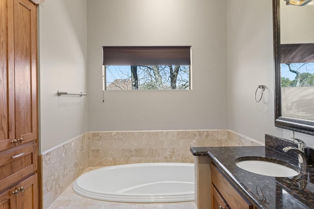 bathroom with a garden tub, double vanity, a sink, and a shower stall