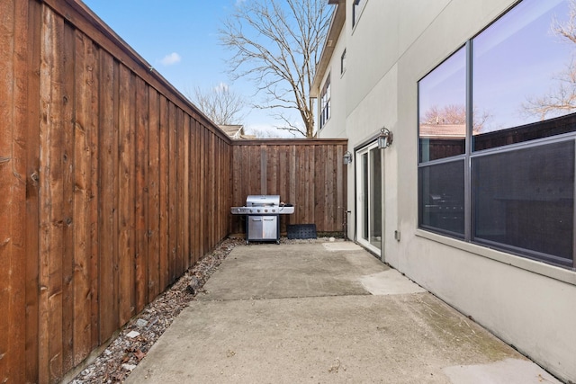 6039 Reiger Ave, Dallas, TX 75214 - view of side of home featuring stucco siding, fence, and a patio area