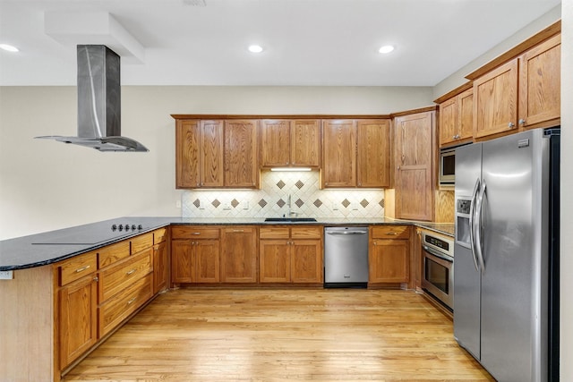 6039 Reiger Ave, Dallas, TX 75214 - kitchen featuring exhaust hood, a sink, a peninsula, brown cabinetry, and appliances with stainless steel finishes