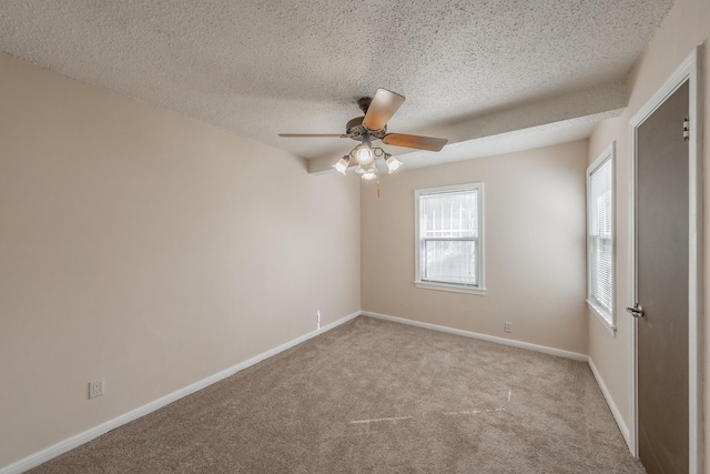 carpeted spare room with ceiling fan and a textured ceiling