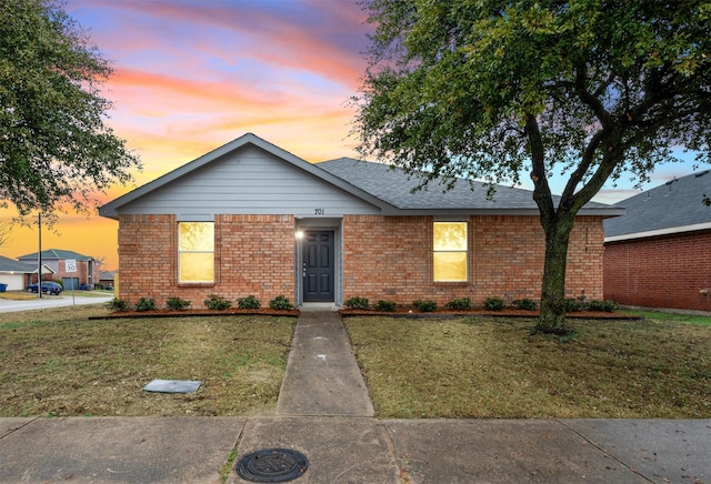 ranch-style home featuring a yard