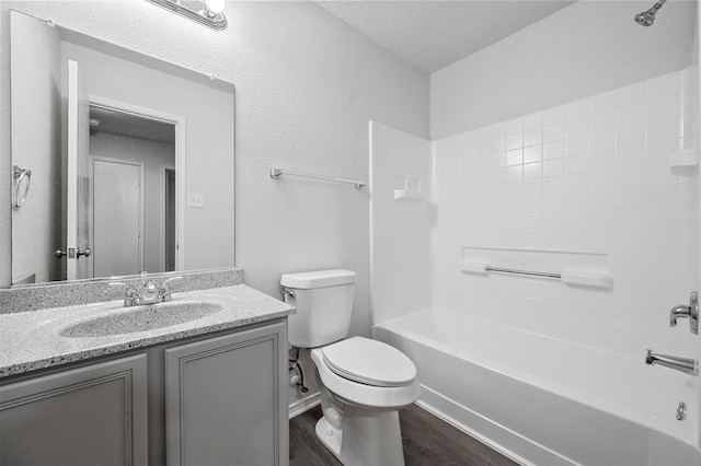 full bathroom featuring toilet, bathtub / shower combination, a textured ceiling, vanity, and hardwood / wood-style flooring