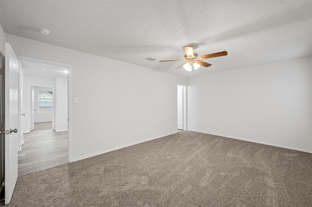 spare room with ceiling fan, carpet floors, and a textured ceiling