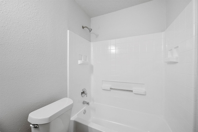 bathroom featuring bathtub / shower combination, toilet, and a textured ceiling