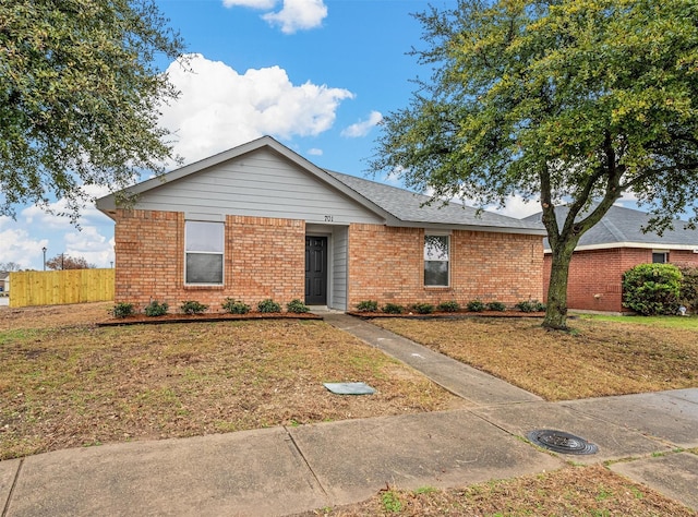 single story home with a front lawn