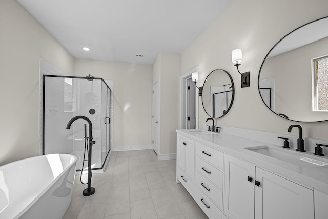 full bathroom with a shower stall, a soaking tub, a sink, and double vanity