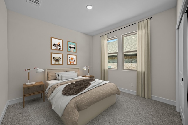 bedroom featuring a closet, visible vents, carpet flooring, and baseboards