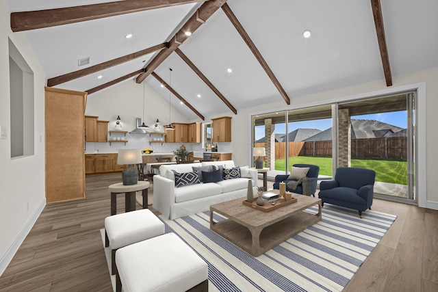 living area featuring beamed ceiling, light wood finished floors, high vaulted ceiling, and recessed lighting
