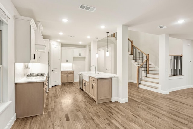 1130 Cardinal Dr, Midlothian, TX 76065 - kitchen featuring light wood-style flooring, baseboards, hanging light fixtures, white cabinets, and recessed lighting